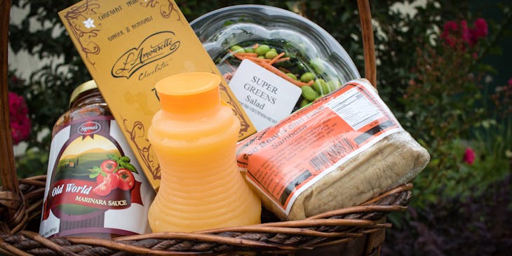 Gift basket with fruit juice and various ingredients.