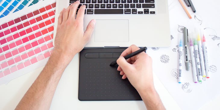 Graphic designer working on a project at a graphic design business.