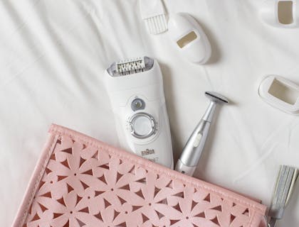 White hair removal tools spilling out of pink bag.