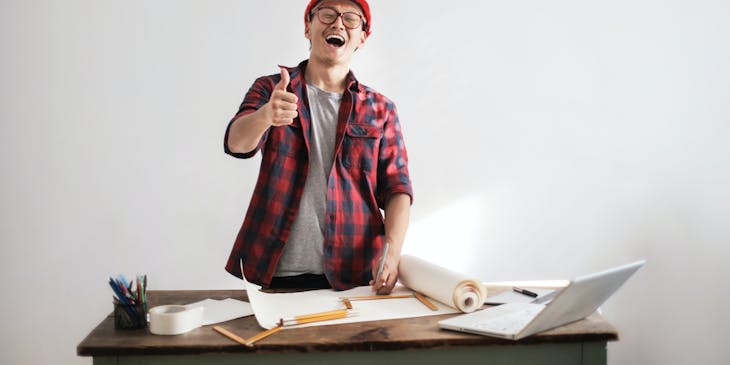 A home inspector looking over blue prints.