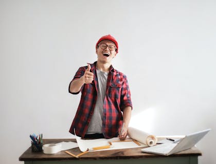 A home inspector looking over blue prints.