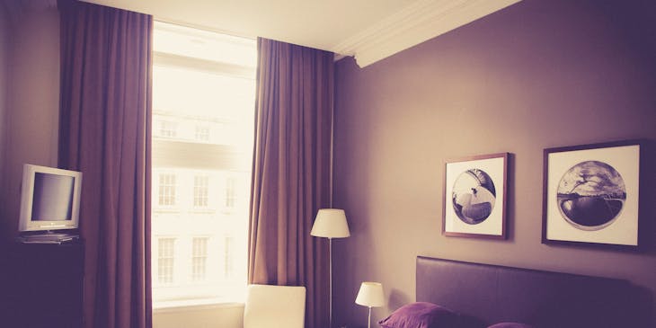 An unoccupied bedroom in a hotel.