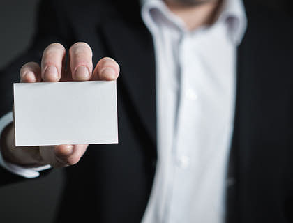 person holding a blank business card