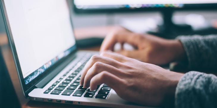 person using a laptop to check if a business name is available