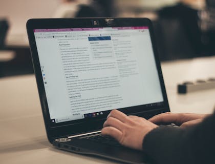 laptop computer with person working on wordpress blog page