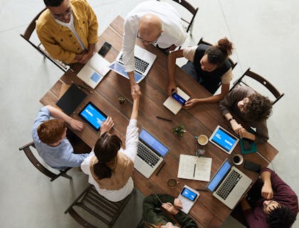 a group of people working on laptops