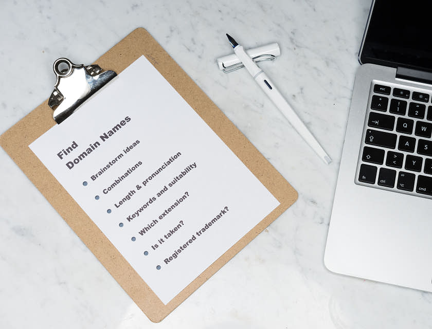 a clipboard next to a laptop