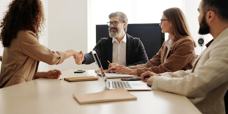 Human resources officers introducing themselves to a new client at their HR company.