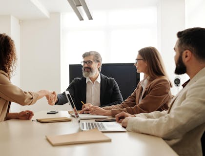 Human resources officers introducing themselves to a new client at their HR company.