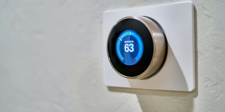 A thermostat displaying the number 63.