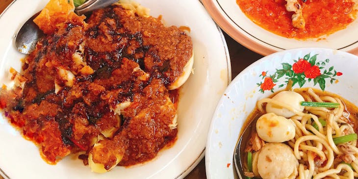 Dishes spread out on table at an Indonesian restaurant.