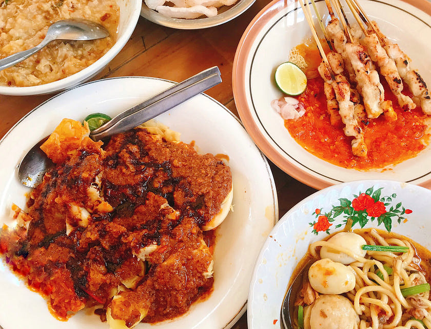 Dishes spread out on table at an Indonesian restaurant.