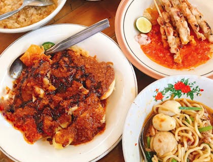 Dishes spread out on table at an Indonesian restaurant.