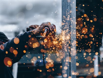 An industrious construction worker using a tool.