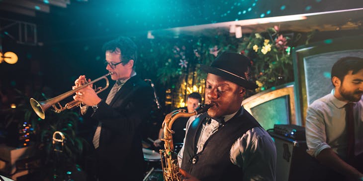 A jazz band playing at a jazz club business.