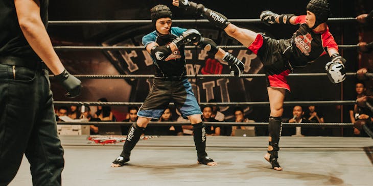 Two men partaking in a kickboxing competition.