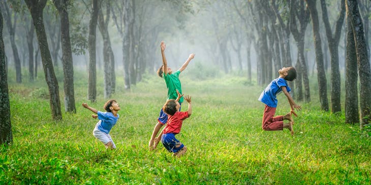 Kids playing with a ball outside.
