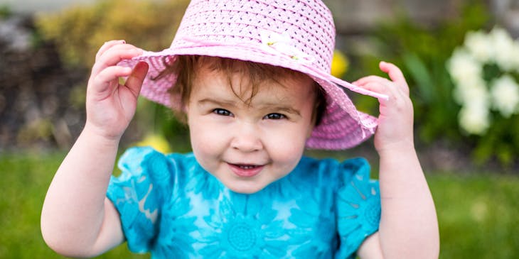 Smiling girl wearing kids' clothing.