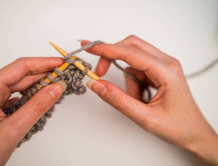 A woman knitting a garment.