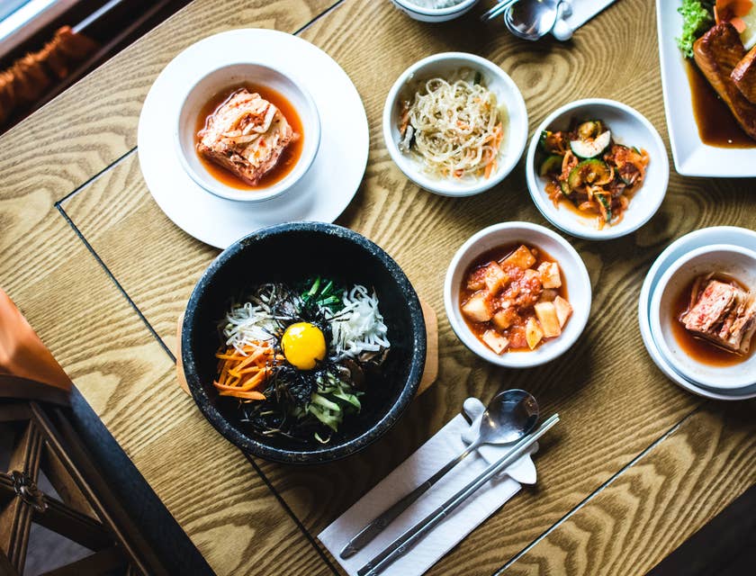 Variety of Korean dishes on a wooden table.