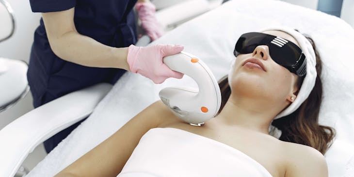 A cosmetic beauty treatment room with laser hair removal equipment.
