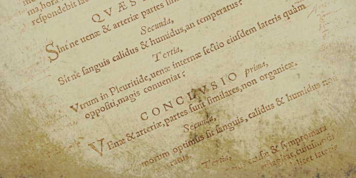 Page from an old book with Latin writing on it.