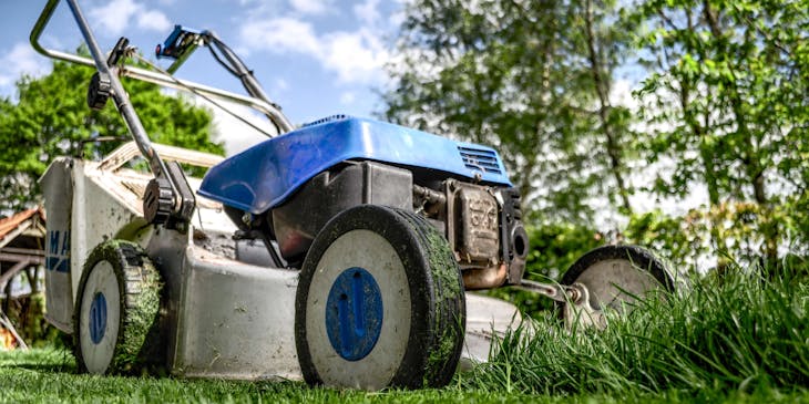 A lawn care business's lawnmower cutting grass.