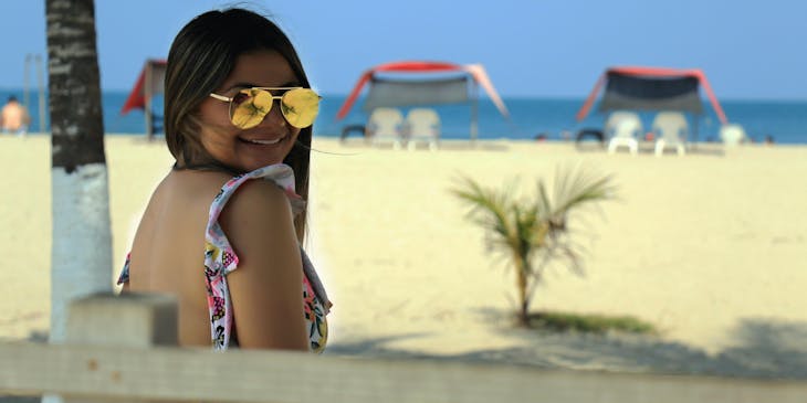 A smiling woman enjoying some leisure time at the beach.