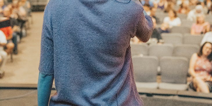 A life coach talking to an audience.