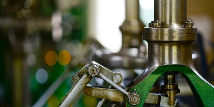 Close up view of green and chrome power tools in machine shop.
