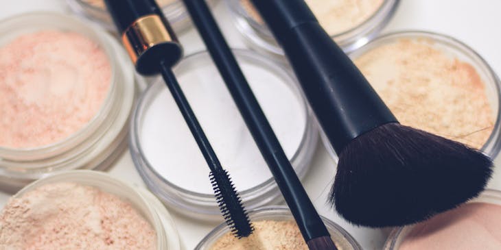 Three makeup brushes and compact powders.