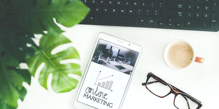 Online marketing text on a tablet at a marketing business.