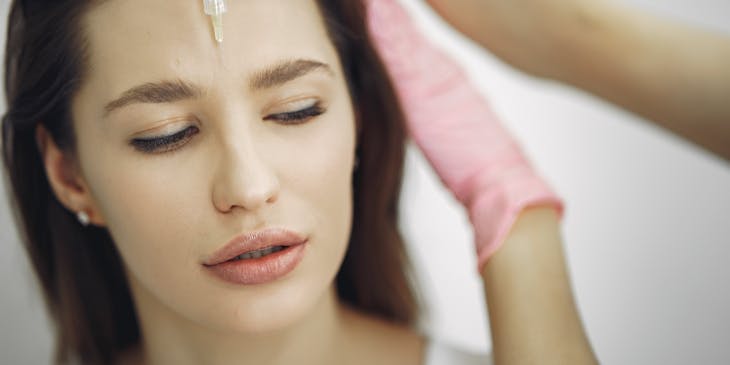 woman having a botox injection in forehead