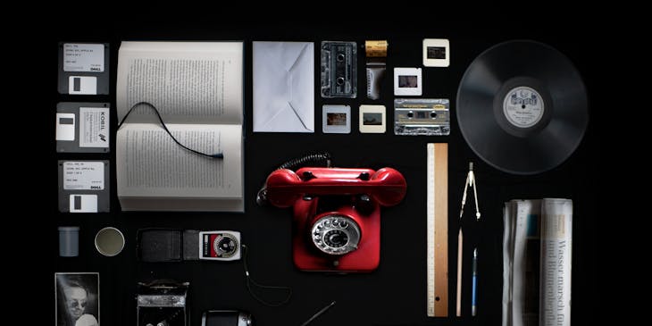 Various forms of media and media capturing devices on a black surface