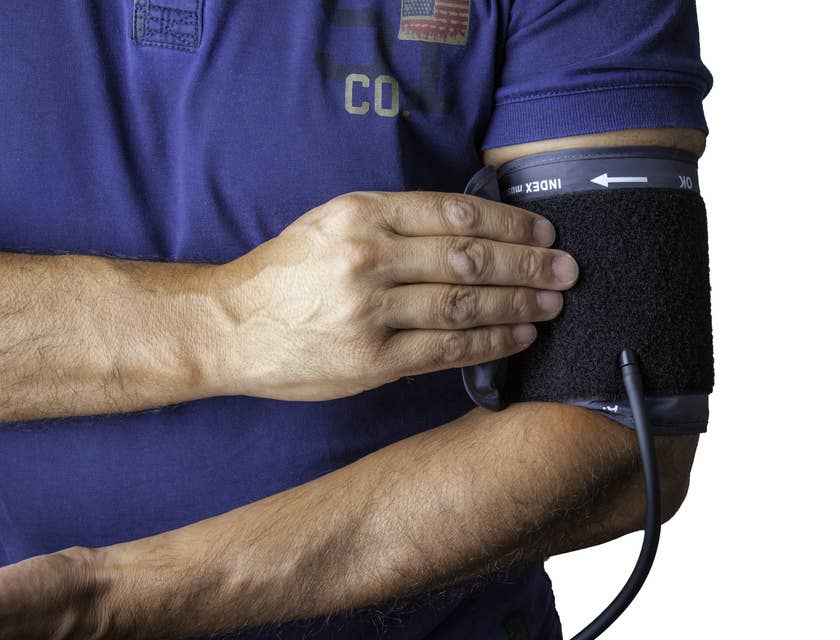 Man wearing a blood pressure cuff acquired from a medical supply store.
