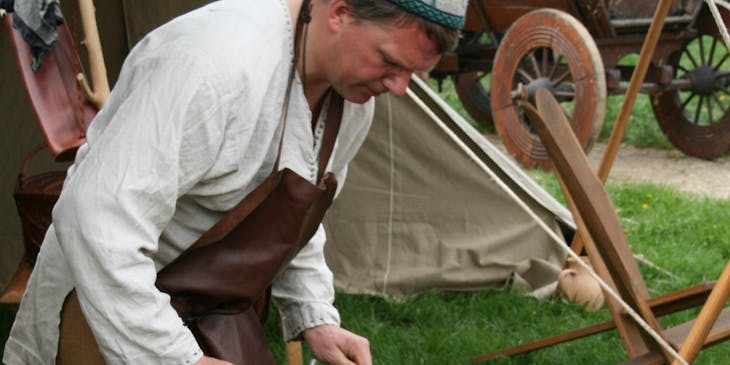 A blacksmith at work in a medieval business..