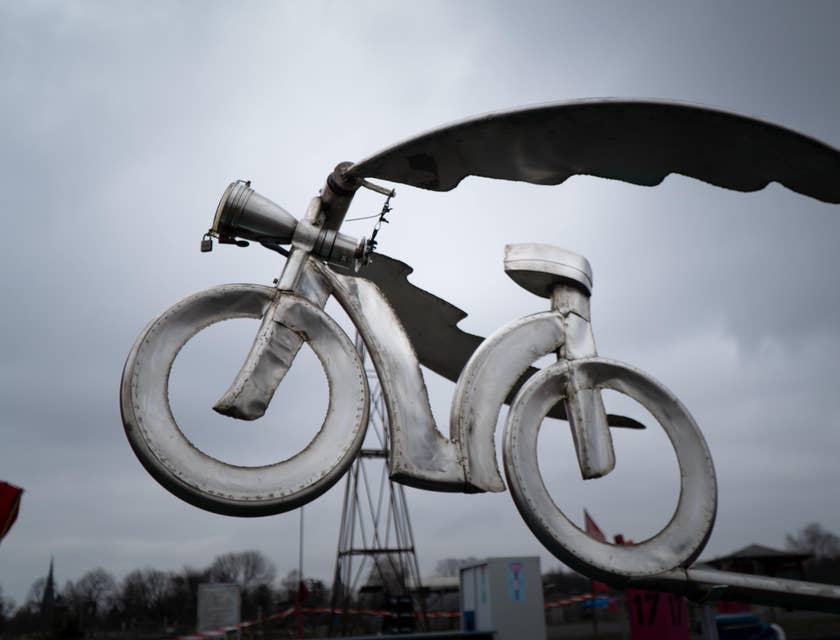 A metal bicycle made by metal art business display in an outside area.