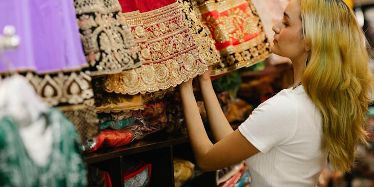 A woman browsing through dresses on display in a Mexican boutique.