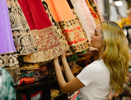 A woman browsing through dresses on display in a Mexican boutique.