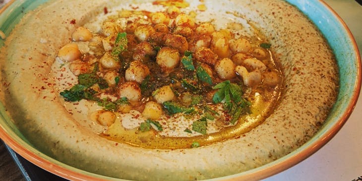 Bowl of hummus at middle eastern restaurant.