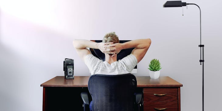 Man sitting at minimalistic business desk.