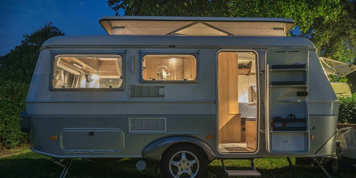 A mobile home in the woods.