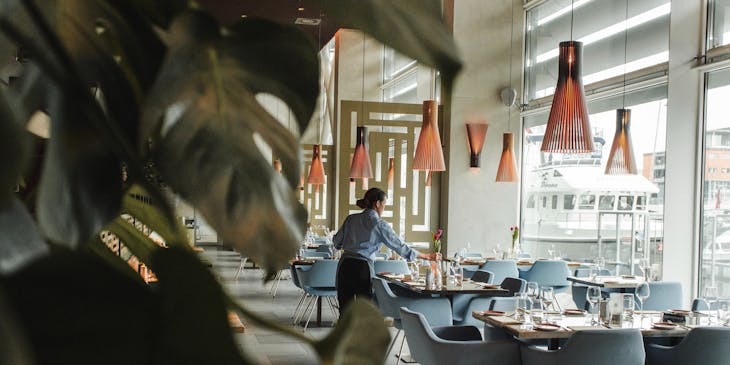 Woman setting up restaurant.