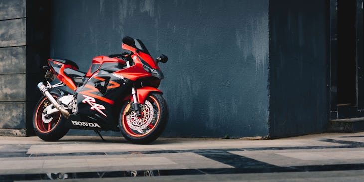 A new motorcycle bought from a dealer in the sunlight.