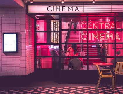 Um cinema iluminado em rosa e vermelho.