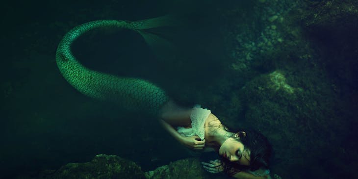 A mythological mermaid sleeping underwater.