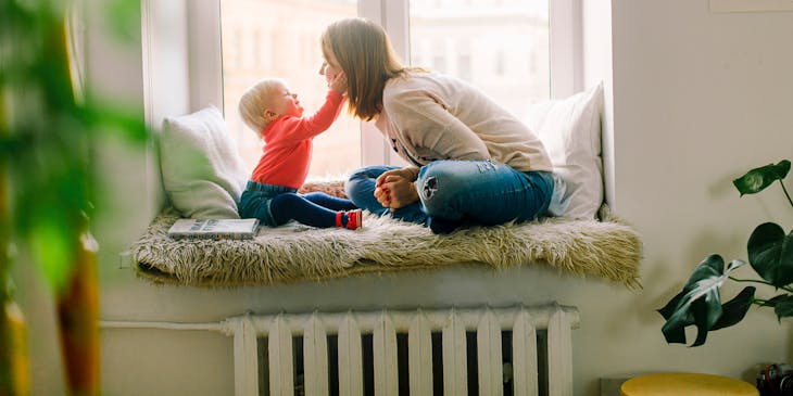 A nanny from a nanny service playing with baby.