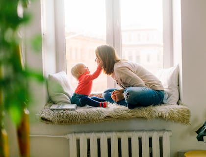 A nanny from a nanny service playing with baby.