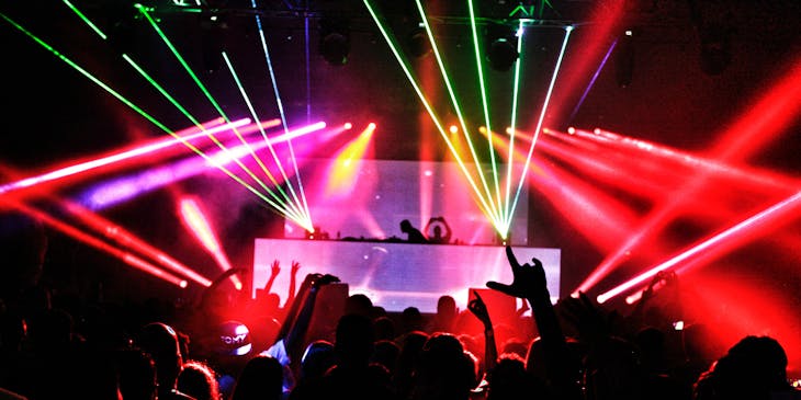 Crowded nightclub with flashing lights.