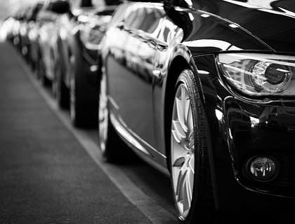 Una fila de autos negros estacionados en una empresa de renting.